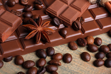 tender milk chocolate and star anise on wooden background