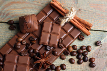 tender milk chocolate and star anise on wooden background