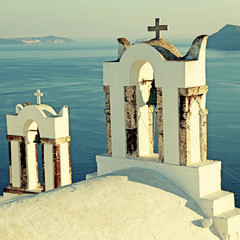 Bell tower of old white church above beautiful blue sea, Santorini