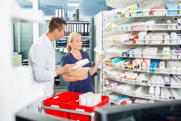 Pharmacist Counting Stock With Assistant