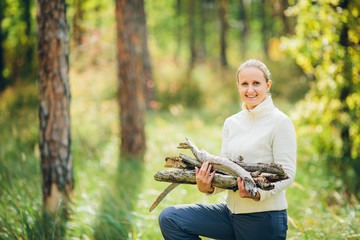 woman gathering wood for a fire