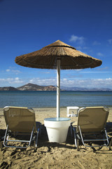 Sunbathing chairs and umbrella on the beach