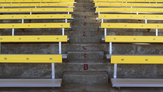 Steps and empty bleachers in a stadium, tilt up, 4k Ultra HD