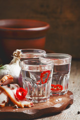 Vodka with spicy red pepper, bacon and garlic, Russian tradition