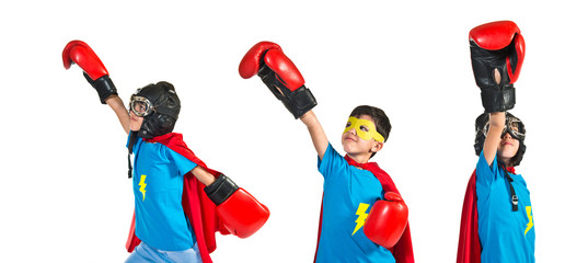 Child dressed like superhero with boxing gloves