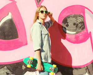 Fashion cool pretty girl wearing a sunglasses, jeans shirt and s