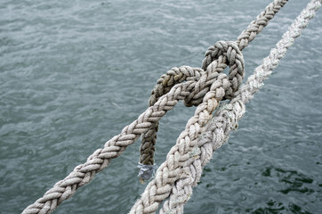 Old ship ropes tightened closeup