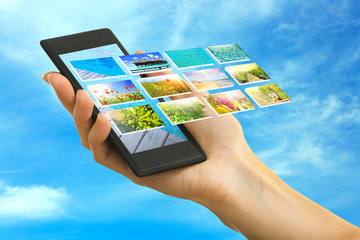 Hand holding smart phone with streaming images