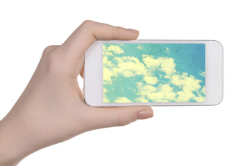 Hand holding mobile smart phone with sky in screen. Cloud computing concept