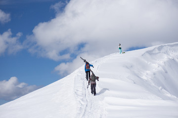Fototapeta na wymiar Skiers walking uphill for freeride