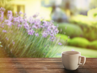 Cup of coffee on table on bright background