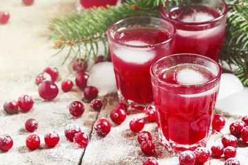 Christmas cranberry cocktail with ice, decorated with fir branch