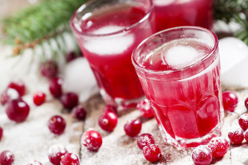 Christmas cranberry cocktail with ice, decorated with fir branch