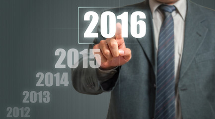 Business Man Touching An Imaginary Screen And Choosing 2016 Year