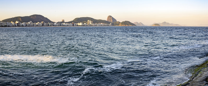 Panoramic view of Copacabana Beach with Sugar Loaf hill and buildings in background