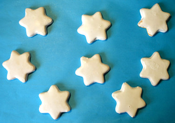 White cookies in the shape of stars on blue background