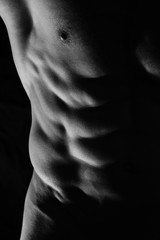 Close-up of perfect male abs, body, low key image. Man, sport, power, muscle