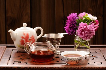 Bouquet of purple and pink asters and teaware for chinese tea ce