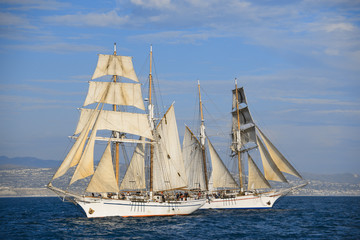 Tall ship sails around Dana Point Harbor.
