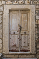 Old weathered wooden door at the Old Town in Dubrovnik, Croatia.