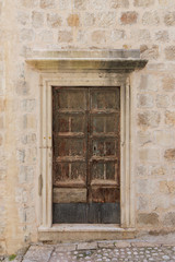 Fototapeta na wymiar Old weathered wooden door at the Old Town in Dubrovnik, Croatia.