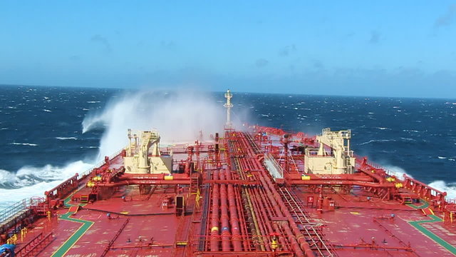 Big ship crashes a waves in the sea.