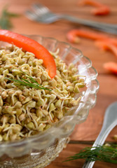 Green raw buckwheat sprouts in a bowl