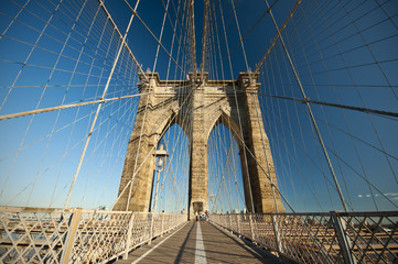 Walkway on the Brooklyn Bridge with blue sky, New York City, USA