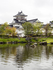 Japanese garden with pond and white castle