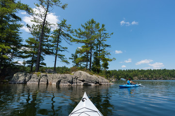 Woman Kayaking on Northern Lake