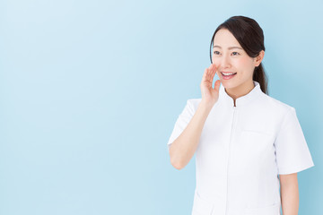 portrait of asian nurse on blue background