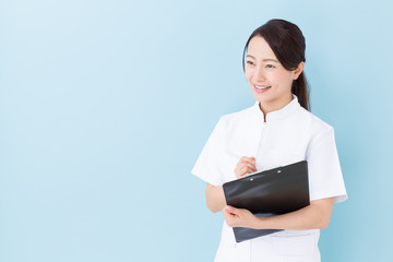 portrait of asian nurse on blue background