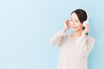 young asian woman listening to music