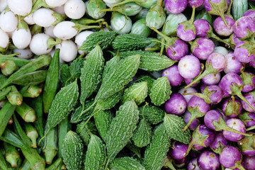 Bitter gourds, Momordica charantia, white, green, purple eggplants