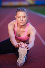 sporty woman on athletic race track