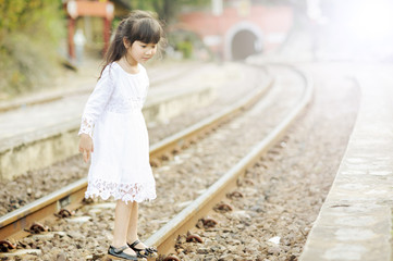 Young little Asian girl on railway