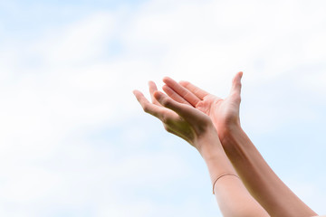 Young woman hand on sky