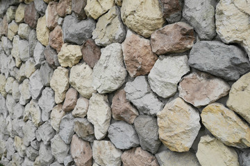yellow, red, blue, stones and pebbles on gray wall, background,