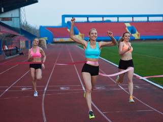 Fototapeta premium Female Runners Finishing Race Together