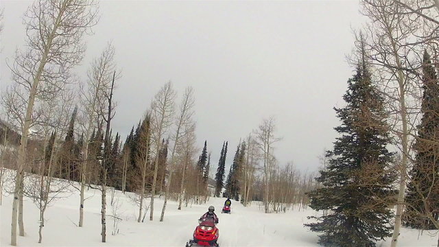 Snowmobile family on winter mountain trail HD 002