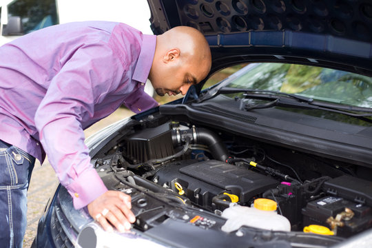 Man Looking At His Car Engine