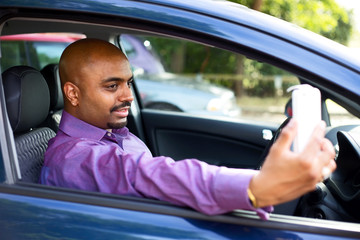 driver taking a selfie in his car