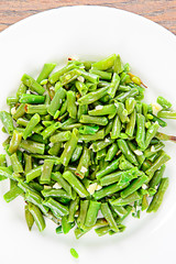 Green Beans Fried with Garlic on a White Plate