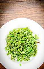 Green Beans Fried with Garlic on a White Plate
