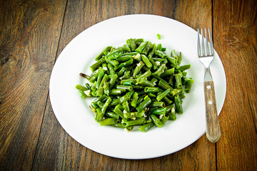 Green Beans Fried with Garlic on a White Plate