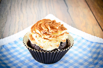 Cake with Cream, Cupcake on Woody Background.