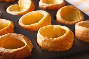 Yorkshire puddings in baking dish macro. horizontal