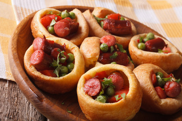 rustic Yorkshire puddings stuffed with sausage and green peas 

