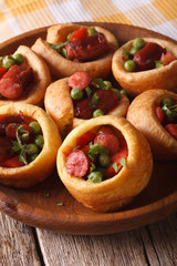 homemade Yorkshire pudding with sausages close-up. Vertical
