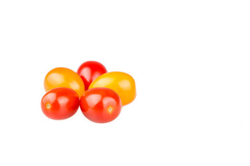 Yellow and red cherry tomatoes on white background